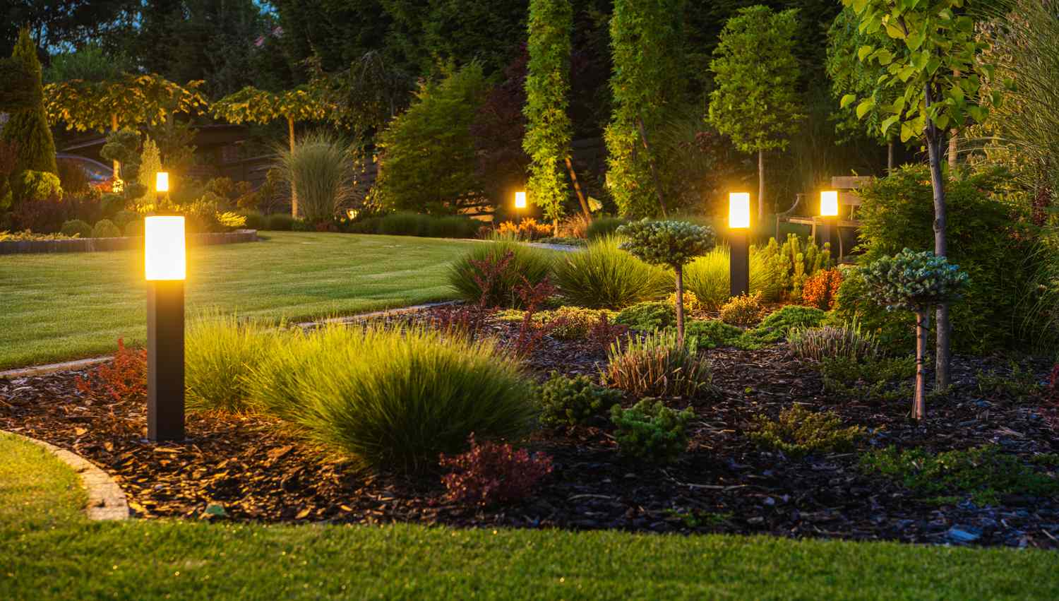 lit garden pathway at night